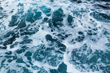 Fototapeta premium Ocean water background with foam. Ocean water splash. Not a calm ocean.