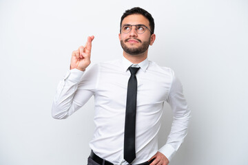 Business Brazilian man isolated on white background with fingers crossing and wishing the best