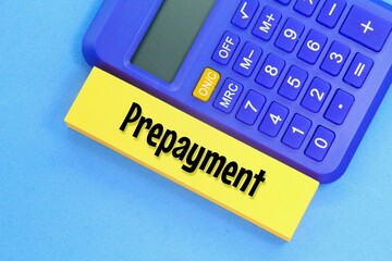 blue calculator and yellow paper with the word prepayment