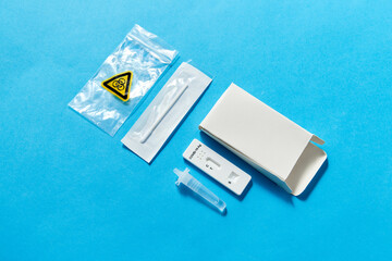 Fototapeta premium medicine, self testing and pandemic concept - coronavirus nasal test kit on blue background