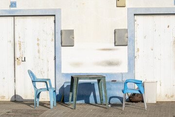 blue table and chairs in the port of Portimao. Algarve, Portugal