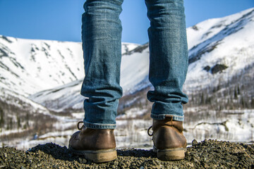 man stand at the foot of the mountain