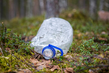 Plastic trash in the forest. World ecology problem.