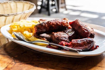 Sausage, veal and pork meat barbecued and served with french fries