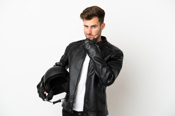 Fototapeta na wymiar Young caucasian man with a motorcycle helmet isolated on white background happy and smiling