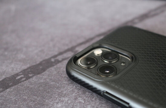 Three cameras detail on black mobile phone