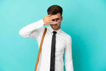 Business man over isolated background covering eyes by hands and smiling