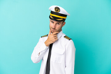 Airplane caucasian pilot isolated on blue background smiling