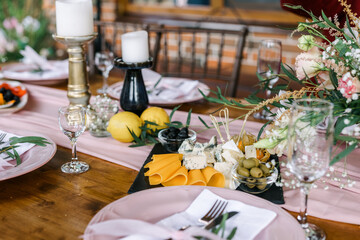 A beautiful outdoor wedding setting in pink flowers. Floral arrangements of white and pink fresh flowers. Lots of candles for dinner. 