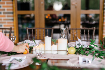A beautiful outdoor wedding setting in pink flowers. Floral arrangements of white and pink fresh flowers. Lots of candles for dinner. 