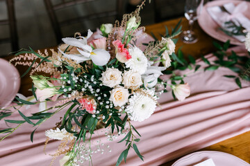 A beautiful outdoor wedding setting in pink flowers. Floral arrangements of white and pink fresh flowers. Lots of candles for dinner. 