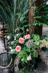 beautiful fresh flowers, a black floor-standing interior candle basket.  The concept of an outdoor party on a summer's day. 