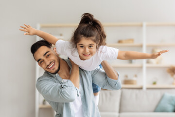 Happy middle-eastern family playing together at home