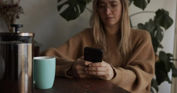Girl is scrolling through feed on her smartphone