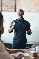 Leadership starts with self-confidence. Shot of a businessman giving a presentation to his...