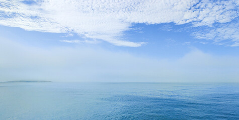 blue sea and sky with white clouds