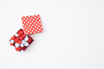 Gift boxes and pom-poms on white  background with empty space. Valentine's Day or Love concept.