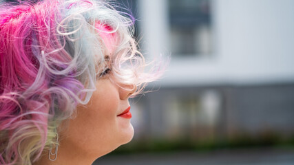 Close-up portrait of curly Caucasian woman with multi-colored hair. Model for hairstyles
