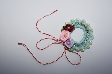 Handmade crocheted Martisor, with red and white string. It is a Romanian traditional symbol of the beginning of spring.