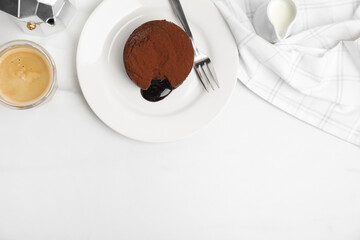 Delicious fresh fondant with hot chocolate served on white table, flat lay. Space for text