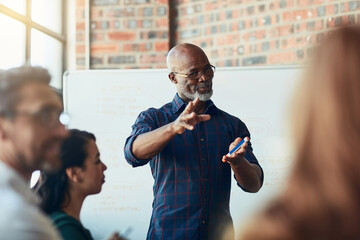 Now there's an idea. Cropped shot of a mature businessman giving a presentation in the boardroom.