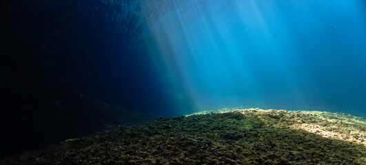 Rays of light at the edge of deep blue sea - Underwater photo