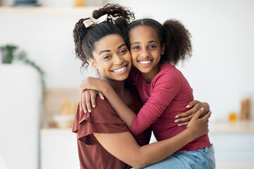 Closeup portrait of happy black mother and daughter