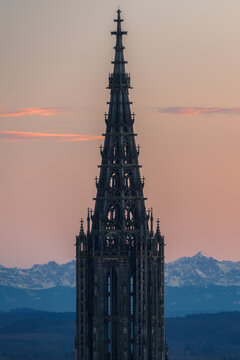 Minster in Ulm at sunset with mountains alps in the background in winter