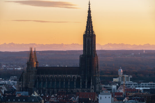 Minster in Ulm at sunset with mountains alps in the background in winter