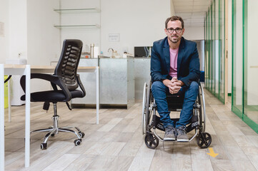 adult businessman in a wheelchair in the middle of the corridor