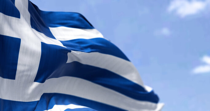 Detail of the national flag of Greece waving in the wind on a clear day