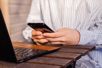 ビジネス用　パソコン作業しながらスマホを打つ女性