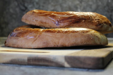 Two loaves of fresh home cooked asian bred on a wooden board