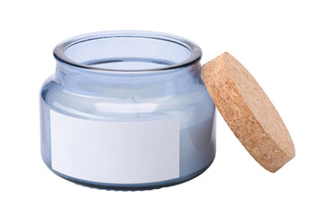 one scented candle in glass with a cork lid lying next to it on a white insulated background