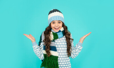 express positive emotion. winter fashion. amazed kid with curly hair in hat and scarf.