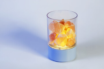 Night light aromatic lamp with himalayan salt with pink stones, on light surface with copy space