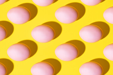 Pink eggs on a yellow background
