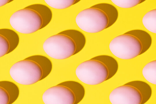 Pink eggs on a yellow background
