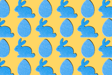 Blue rabbits and blue eggs pattern on a yellow background