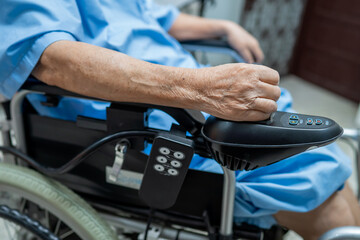 Asian senior or elderly old lady woman patient on electric wheelchair with remote control at nursing hospital ward, healthy strong medical concept