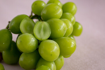 Ripe green korea grape fruit put in wooden bamboo basket  hand made cloth background.