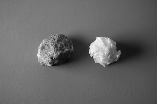 Rock and crumpled paper ball