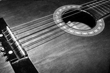 Obraz premium Close Up of an Old Vintage Acoustic Guitar Strings and Neck in Black and White