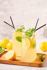 Lemonade with lemon, mint and ice cubes in glass