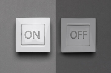 Turned ON and OFF light switches on grey background