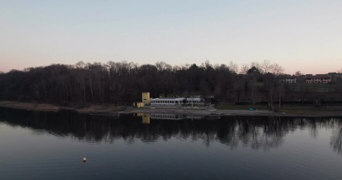 Closed lido on Lake Pusiano in winter. Aerial parallax shot.