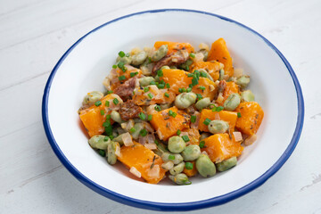 Sautéed pumpkin with broad beans. Spanish traditional tapas.