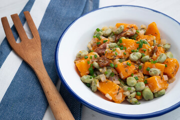 Sautéed pumpkin with broad beans. Spanish traditional tapas.