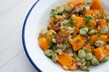 Sautéed pumpkin with broad beans. Spanish traditional tapas.
