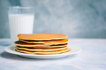 Tasty pancakes in a white plate on the table. copy space